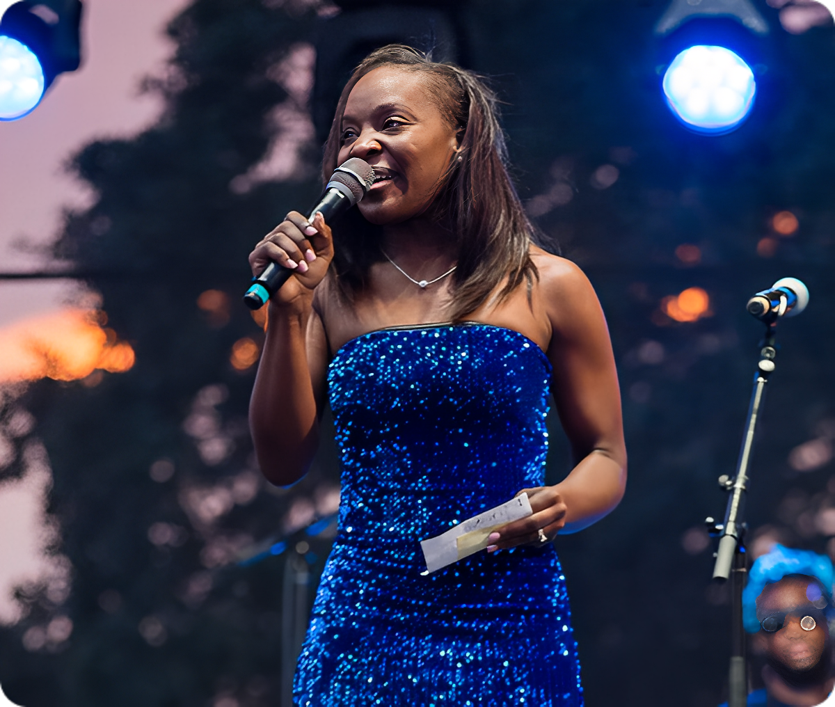 Female artist holding microphone at event
