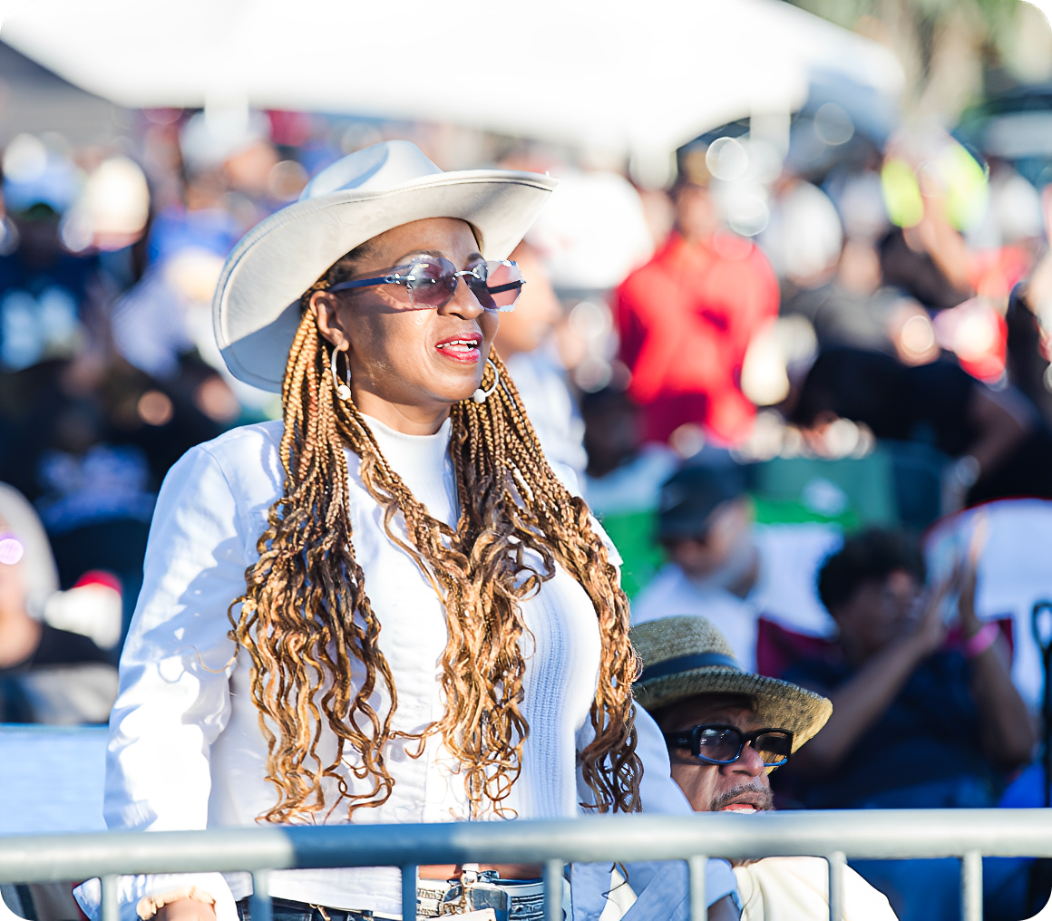 Outdoor gathering with woman in white outfit