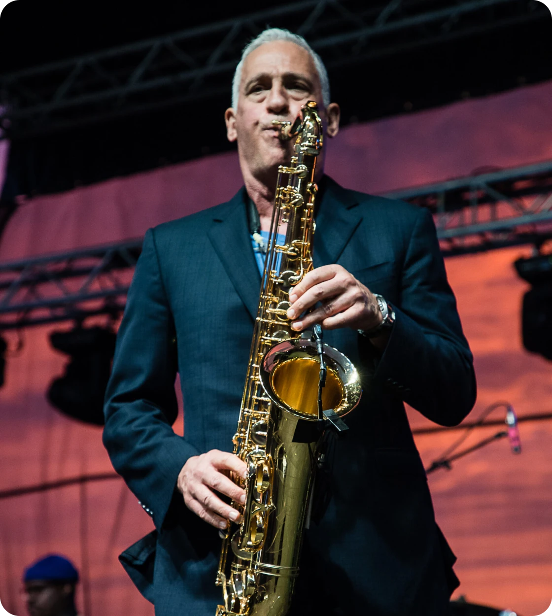 Musician with saxophone in spotlight