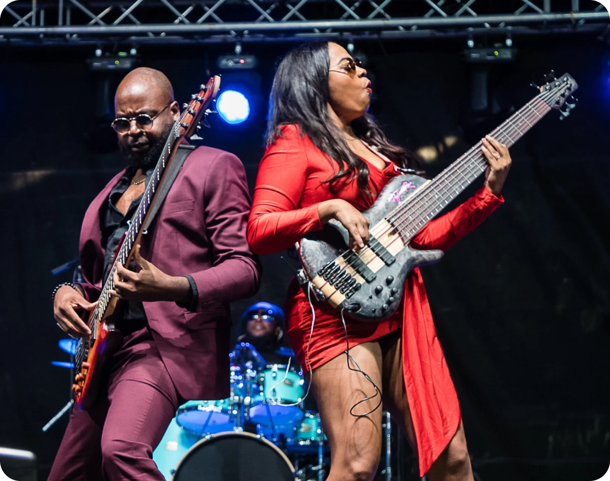 Bass player in red dress on stage